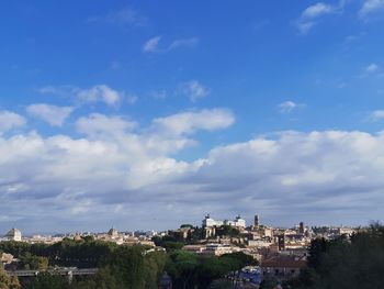 Buildings in city against sky