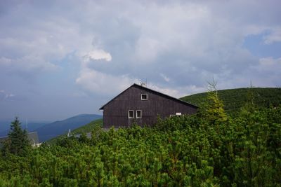 Scenic view of mountains against cloudy sky