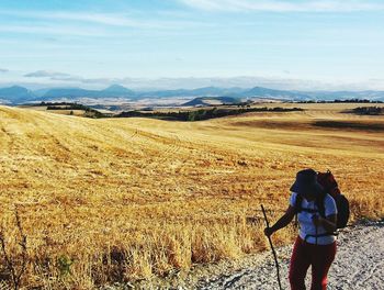 Woman hiking at sierra del perdon against cloudy sky