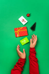 High angle view of woman holding gift box against blue background