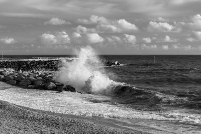 Waves washing up on the rocks at west bay in dorset.