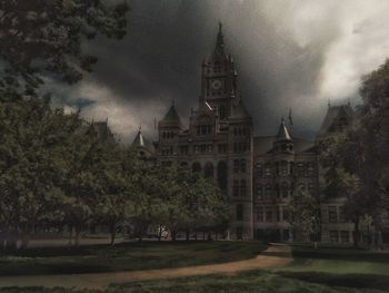 Panoramic view of buildings and trees against sky