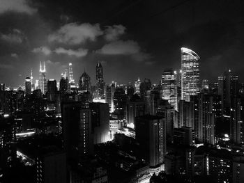 Illuminated buildings in city against sky at night. black and white portrait from shanghai. 
