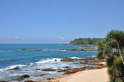 Scenic view of sea against clear blue sky