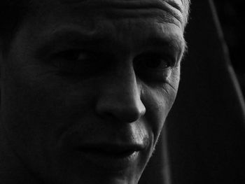 Close-up portrait of handsome young man in darkroom