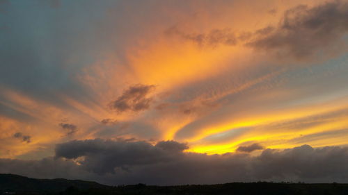 Scenic view of dramatic sky during sunset