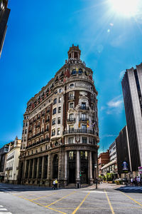 Low angle view of buildings against blue sky