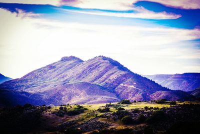 Scenic view of mountains against cloudy sky