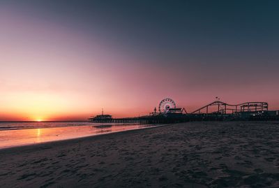 Scenic view of beach against sky during sunset