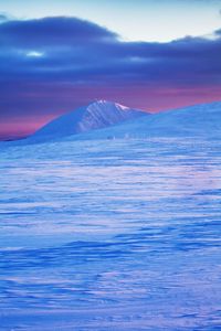 Scenic view of snowcapped mountain against sky during sunset