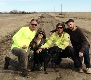 Portrait of happy friends sitting in farm