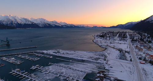 Scenic view of snowcapped mountains against sky during sunset