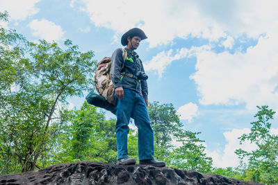 Low angle view of man standing against sky