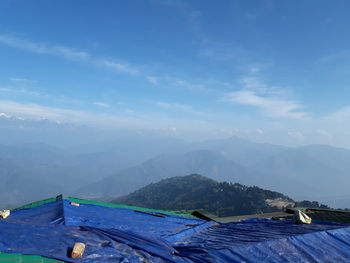 Scenic view of mountains against blue sky