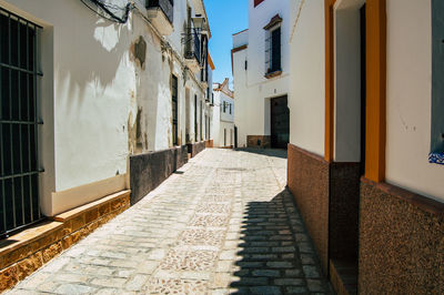 Empty alley amidst buildings in city