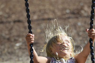 Cheerful girl on swing