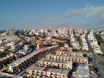 High angle view of buildings in city against sky