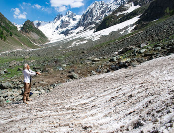 Rear view of man walking on mountain