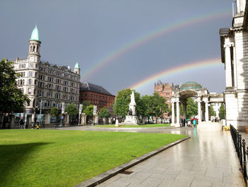 Rainbow over buildings in city