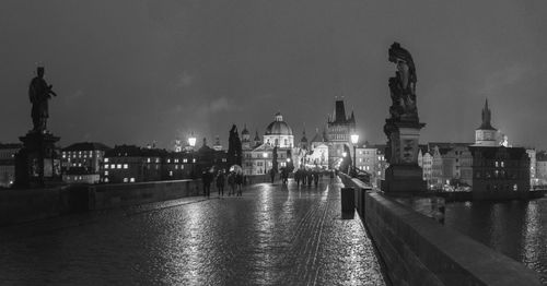 Charles bridge against sky in city at night