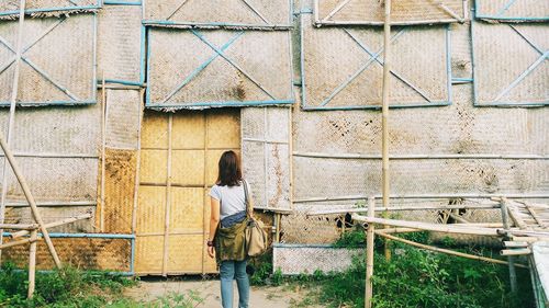 Female tourist in front of an obsolete building