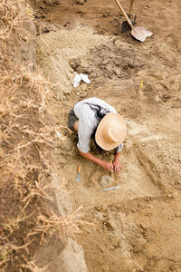 High angle view of woman working in dirt