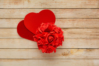 Directly above shot of red rose on wooden table