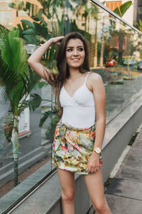 Portrait of a smiling young woman standing outdoors