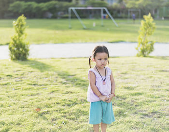 Full length of young woman standing on field