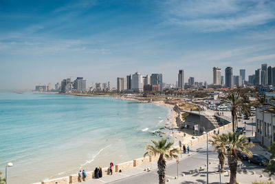 High angle view of buildings by sea against sky