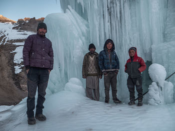 People standing on snow covered landscape during winter