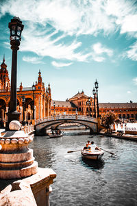 Boats in sea against cloudy sky