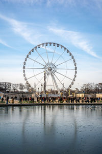 People by ferris wheel at amusement park