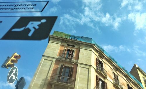 Low angle view of building against cloudy sky