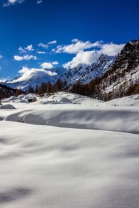 Scenic view of snow covered mountains against sky