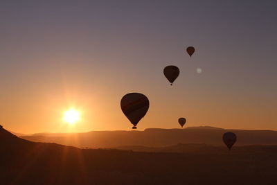 Hot air balloon flying in sky during sunset