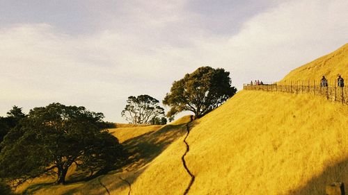 Scenic view of sand dunes against sky