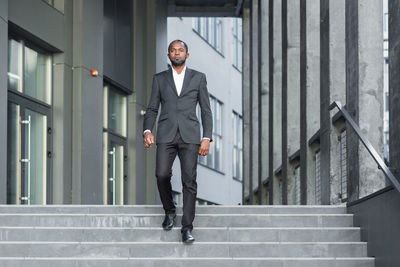 Full length of man walking on steps