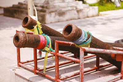 Close-up of rusty pipe against railing