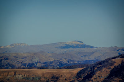 Scenic view of mountains against clear blue sky