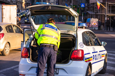 Rear view of man working on street