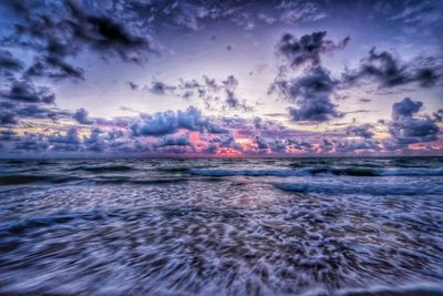 Scenic view of sea against cloudy sky