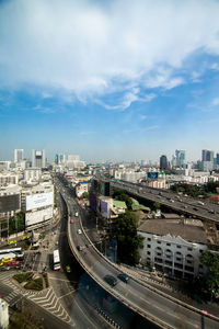 High angle view of city street and buildings against sky