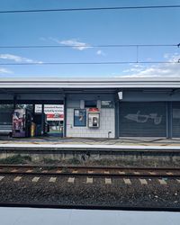 Train at railroad station against sky