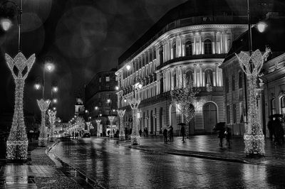 People on wet street at night