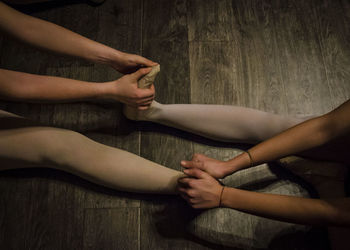 Low section of ballet dancer on hardwood floor