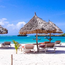 Scenic view of beach against blue sky