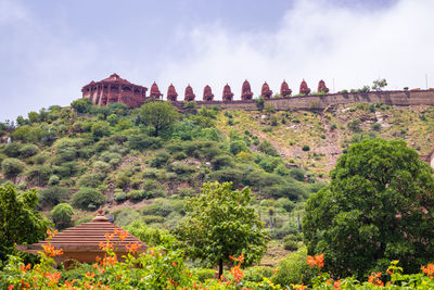 Artistic series or red stone jain temple at mountain top at morning from unique angle