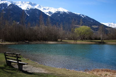 Scenic view of lake by mountains against sky