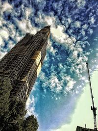 Low angle view of tower against cloudy sky